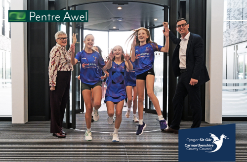 School children jumping at the opening of Pentre Awel